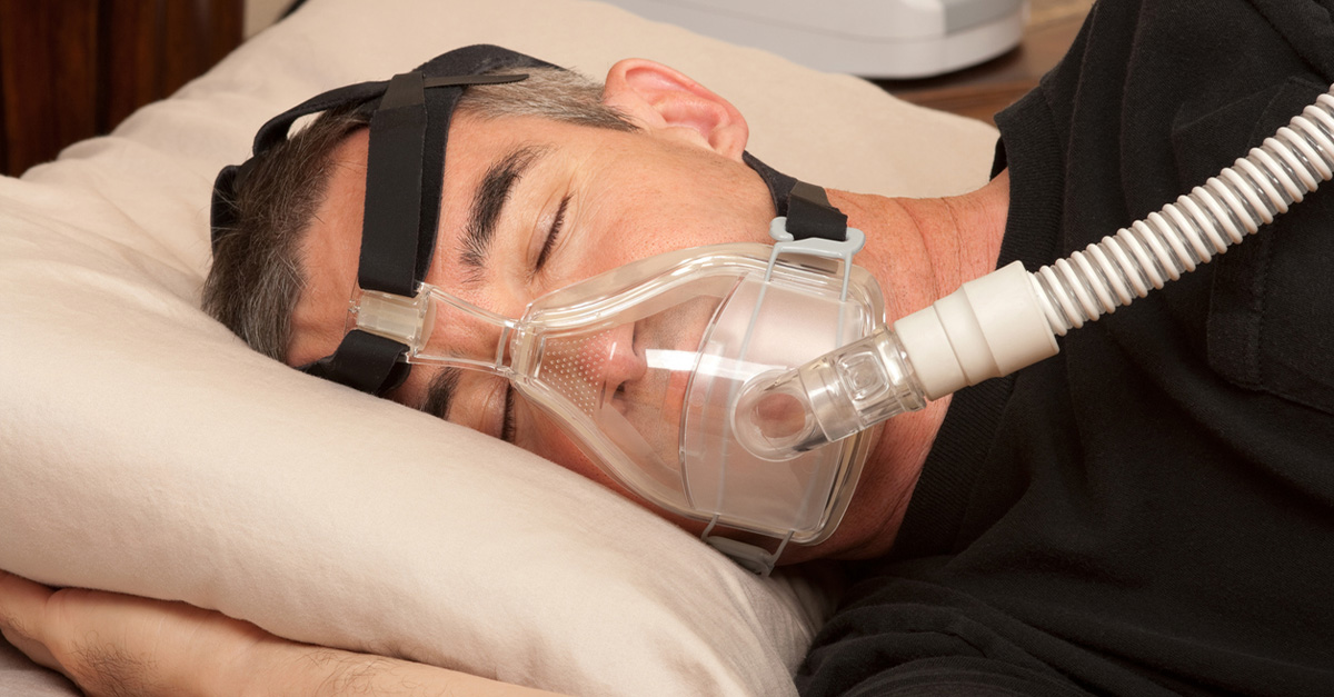 man sleeping with a CPAP